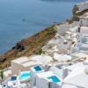 Stunning view of Santorini's white architecture with the Aegean Sea in the background. Perfect for travel enthusiasts.
