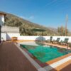 Relax at a luxurious villa with mountain-view pool and sun loungers.