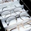 Close-up of assorted eyeglasses showcased in an orderly fashion for selection.