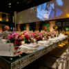 Luxurious wedding reception setting with vibrant floral arrangements and elegant decor.