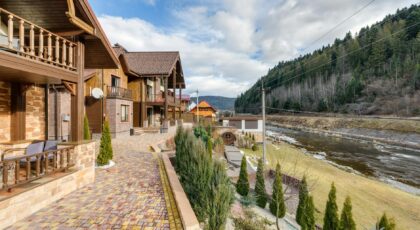 Elegant riverside resort surrounded by lush forest scenery, perfect for relaxation and vacation.