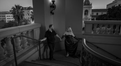 A stylish couple ascends stairs at a Pasadena venue, enhancing elegance and charm.