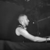 Black and white image of a DJ performing live, capturing the focus and energy of the performance.