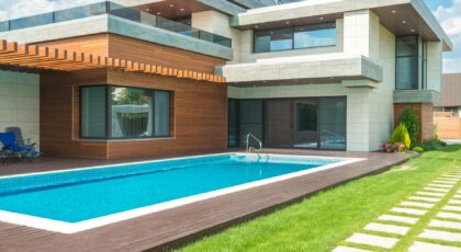 A stunning modern house with a spacious pool and green garden, ideal for relaxation.