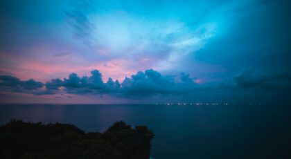 Experience the serene twilight sky over Bali's coastline, capturing a stunning blend of colors and peaceful ocean views.