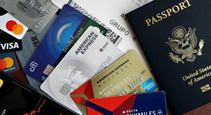 A collection of travel essentials including a passport, credit cards, and a boarding pass. Ideal for travel and finance concepts.
