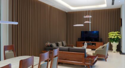 Stylish living room featuring modern furniture, soft lighting, and elegant brown curtains.