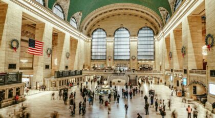 Bustling interior view of Grand Central Terminal with commuters and iconic architecture.